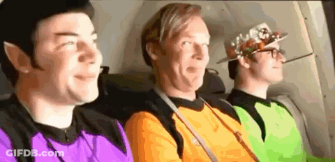 Three Men Sitting In Back Seat Of Plane GIF
