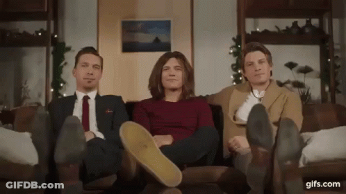 Three Men Sitting On Couch With Feet Up GIF