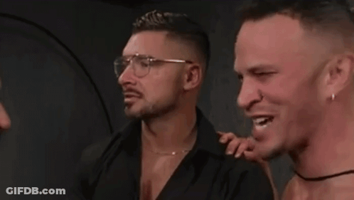 Three Men Smiling, One With Glasses And Earrings GIF