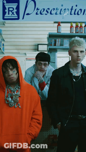 Three Men Stand In Front Of A Prescription Sign GIF