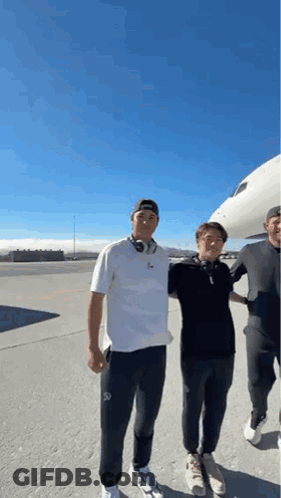 Three Men Standing Beside Airplane On Runway GIF
