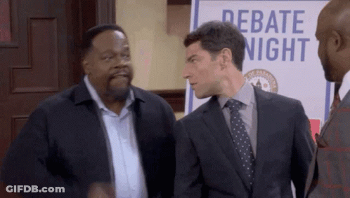 Three Men Standing In Front Of Debate Sign GIF