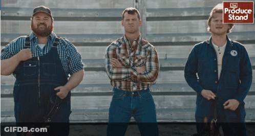 Three Men Standing In Front Of Produce Stand GIF
