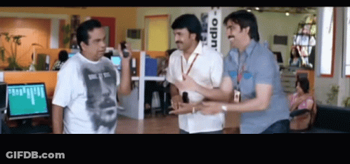Three Men Standing In Front Of Studio Sign GIF