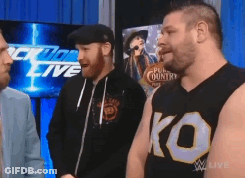Three Men Standing In Front Of Wrestling Live Screen GIF