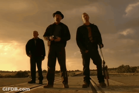 Three Men Standing Next To Each Other On A Road Holding Guns GIF