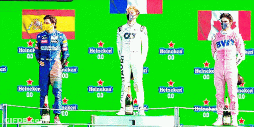 Three Men Standing On A Podium With Heineken Written On The Back GIF