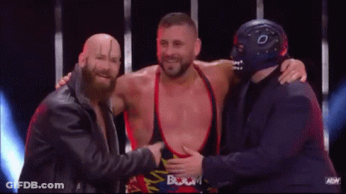 Three Men Standing On Stage One Wearing Mask GIF