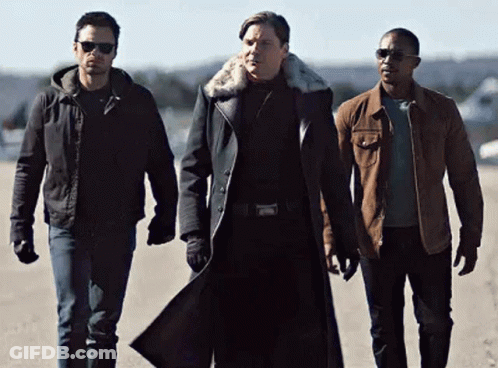 Three Men Standing Together On Dirt Road GIF