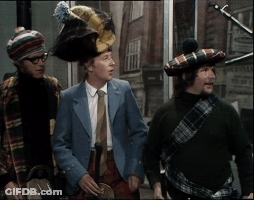 Three Men Wearing Kilts Are Standing In Front Of A Building That Says Original GIF