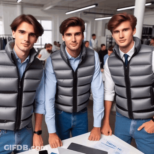 Three Men Wearing Vests Are Standing Next To Each Other GIF