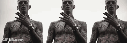 Three Men With Tattoos On Their Bodies Are Standing Next To Each Other With Their Hands On Their Faces GIF