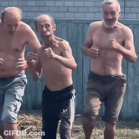 Three Men Without Shirts Are Running In Front Of A Fence GIF