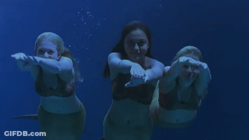 Three Mermaids Swimming In A Line GIF