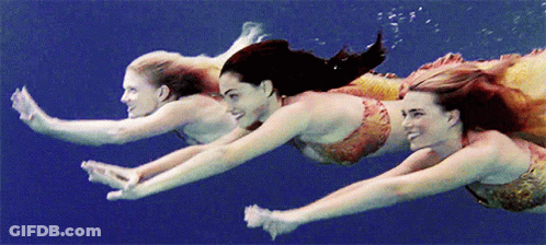 Three Mermaids Swimming Underwater Smiling GIF