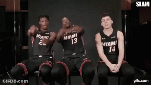Three Miami Heat Basketball Players Are Sitting Next To Each Other In Chairs . GIF
