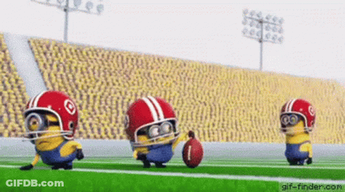 Three Minions Are Playing Football On A Field Wearing Helmets And Holding A Ball . GIF