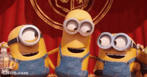 Three Minions In Overalls And Goggles Standing Together GIF
