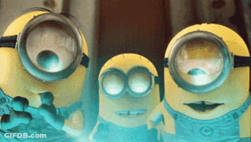 Three Minions Wearing Goggles Looking At Camera GIF