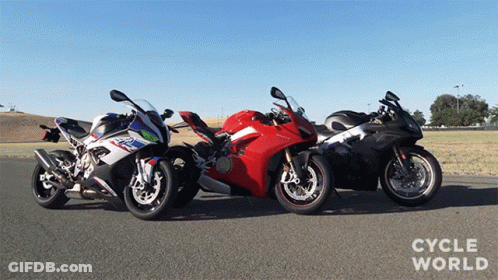 Three Motorcycles Are Parked Next To Each Other With Cycle World Written On The Bottom Right GIF