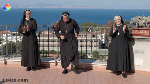 Three Nuns Dancing On Balcony Overlooking Ocean GIF