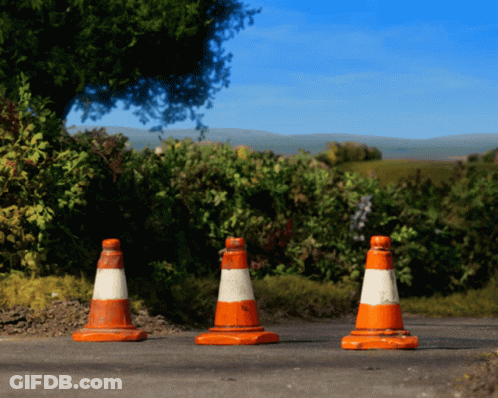 Three Orange And White Traffic Cones On Road GIF