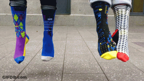 Three Pairs Of Socks Hanging From Feet With Pac-Man GIF