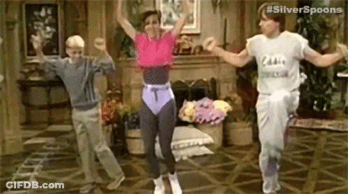 Three People Are Dancing Together In A Living Room . GIF