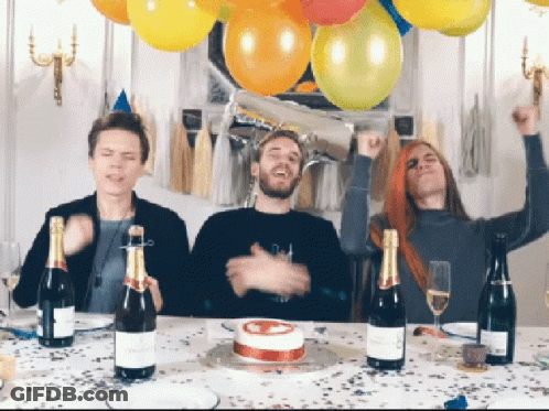 Three People Are Sitting At A Table With Bottles Of Champagne And A Birthday Cake GIF