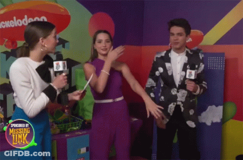Three People Are Standing In Front Of A Nickelodeon Logo GIF