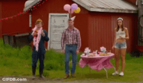 Three People Are Standing In Front Of A Pink Table With Balloons On It GIF