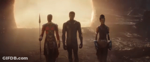 Three People Are Standing Next To Each Other In A Cave . GIF