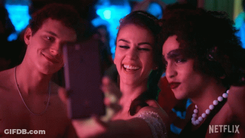 Three People Are Taking A Selfie With A Netflix Logo In The Background GIF