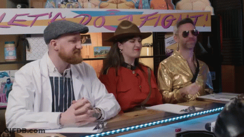 Three People At Table With Lets Do A Fight Sign GIF