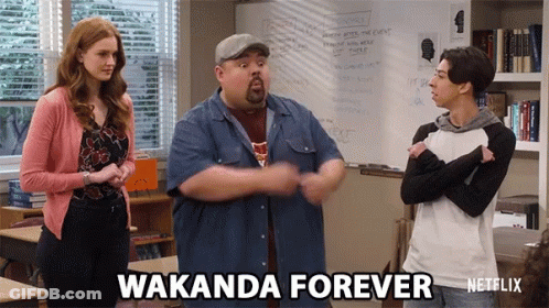 Three People In A Classroom With Wakanda Forever Written On The Screen GIF