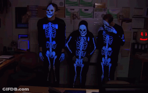 Three People In Glow In The Dark Skeleton Costumes GIF