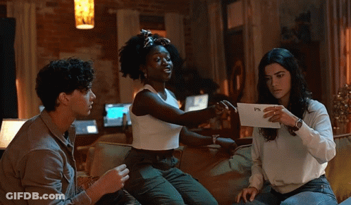 Three People On Couch One Holding Paper Saying PS GIF