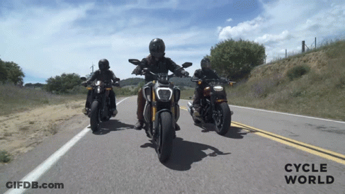Three People Riding Motorcycles On A Road With The Words Cycle World On The Bottom Right GIF