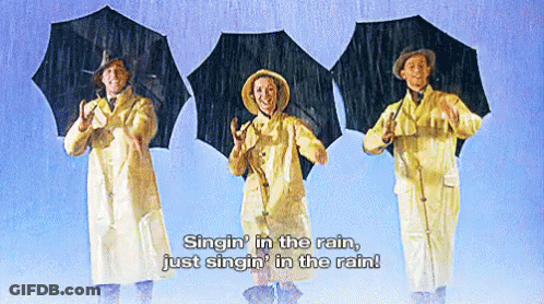 Three People Singin' In The Rain With Umbrellas GIF