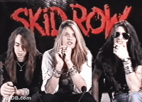 Three People Sitting Before Skid Row Sign GIF