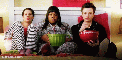 Three People Sitting On Bed With Popcorn GIF