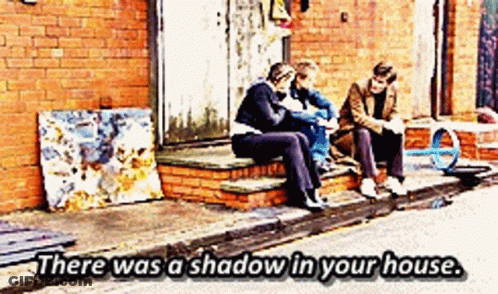 Three People Sitting On Brick Steps Saying There Was A Shadow In Your House GIF