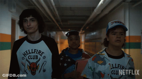 Three People Walking Down Hallway Hellfire Club Shirt GIF
