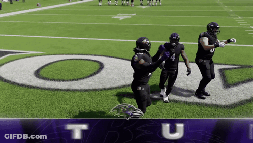 Three Ravens Players Standing On Football Field GIF