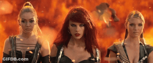 Three Red-Haired Women Standing In Front Of Fire GIF