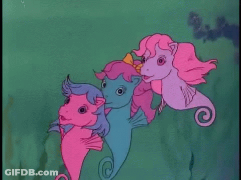 Three Seahorses Swimming GIF