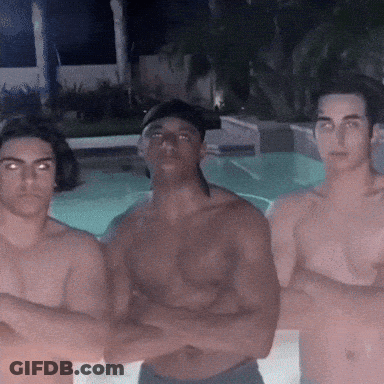 Three Shirtless Men Are Posing For A Picture In Front Of A Pool GIF