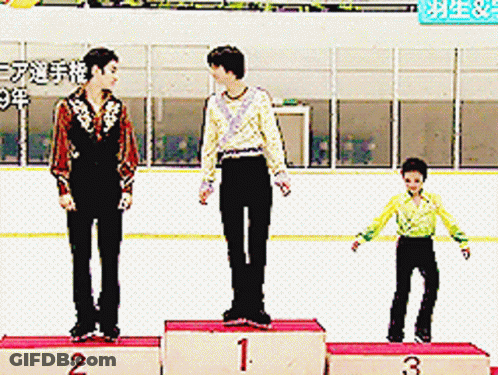 Three Skaters Are Standing On A Podium With Numbers 1 2 And 3 On Them GIF