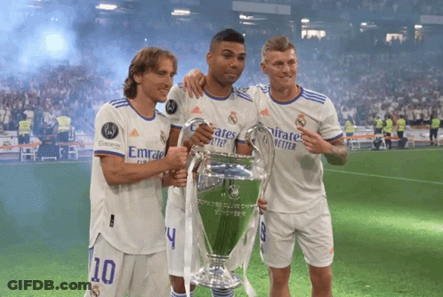 Three Soccer Players Holding A Trophy With Emirates Better Written On Their Shirts GIF