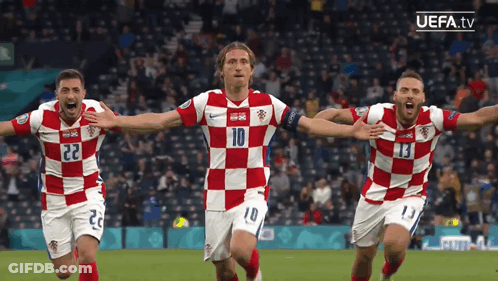 Three Soccer Players Wearing Red And White Checkered Jerseys With The Number 10 On The Front GIF